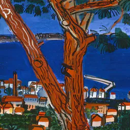 Painted orange tree trunk in front of a blue bay and red roofs